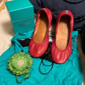 Beautiful cardinal red Tieks with all of the items that come with them.
